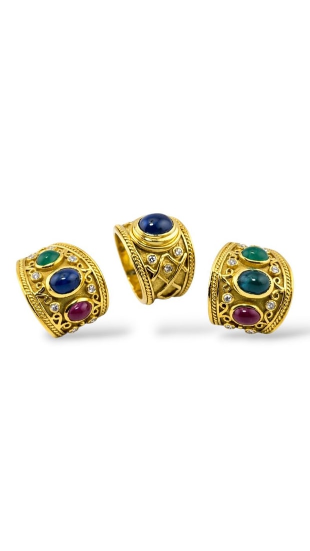18K Yellow Gold Sapphire Diamond Ring: 18K Yellow Gold Diamond Ring A bold and substantial vintage ring crafted in rich 18 karat yellow gold, centered by a striking oval cabochon sapphire. The smooth domed surface of the sapphire enhances 