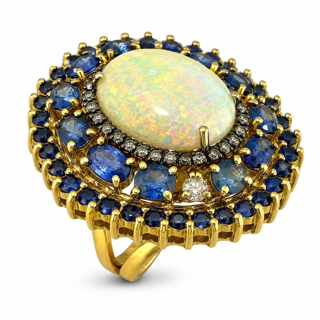 18K Yellow Gold 3.60ct Sapphire 0.91ct Diamond and 5.00ct Opal Cocktail Ring: 18K Yellow Gold 3.60ct Sapphire 0.91ct Diamond and 5.00ct Opal Cocktail Ring A large cocktail ring crafted in yellow gold with a bold gemstone arrangement and strong statement presence. The oval cut