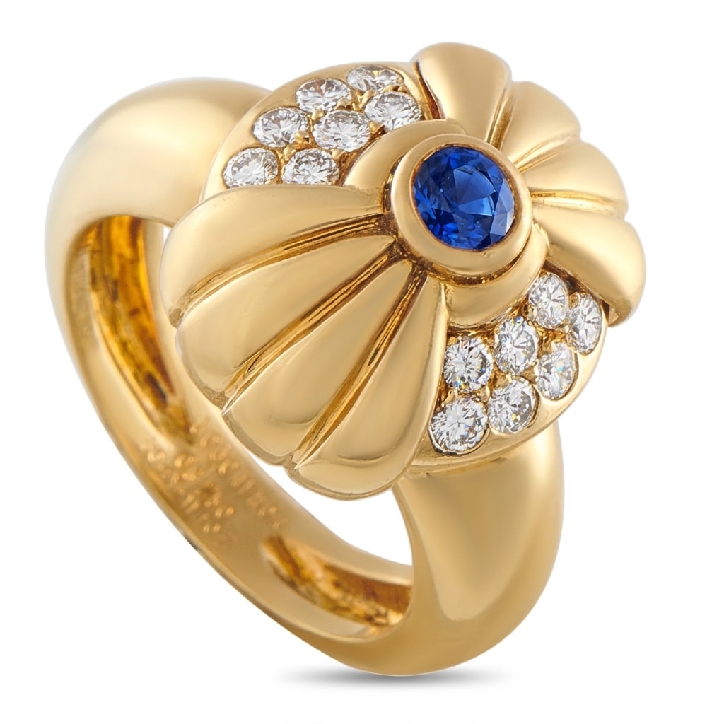 Boucheron 18K Yellow Gold 0.4ct Diamond and Sapphire Ring: Simple and stylish, this Boucheron ring is a classic piece that will never go out of style. Inset Diamonds with a total weight of 0.4 carats make a statement on each side of the design and highlight