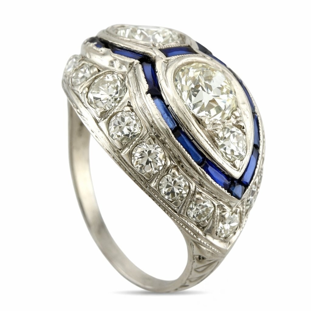 Platinum Art Deco Ring: Platinum Art Deco Ring with 1.6 Carats of Diamonds and Sapphires This elegant platinum Art Deco ring captures the spirit of its era with a striking interplay of geometric form and vibrant color. At it