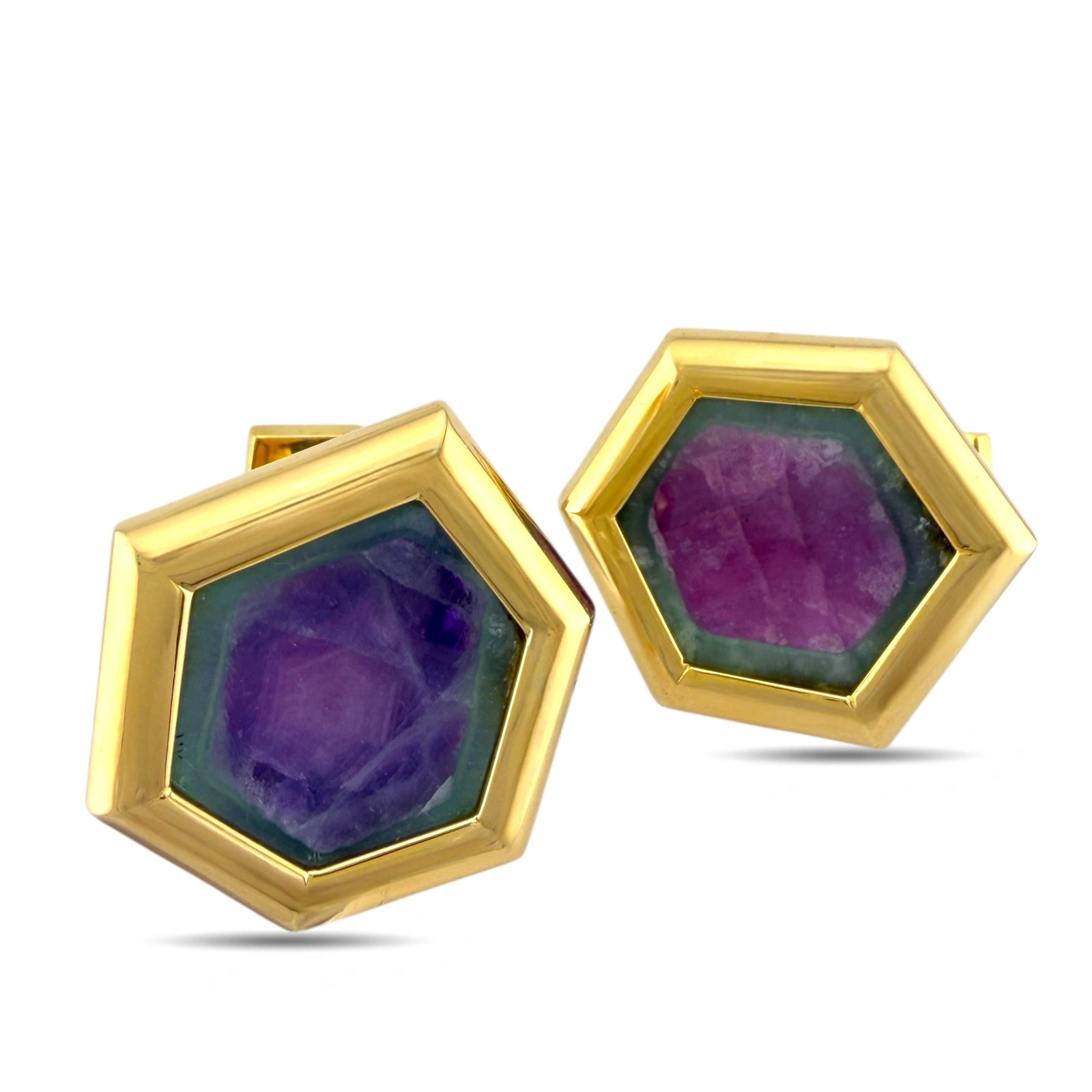 18K Yellow Gold Cufflinks: 18K Yellow Gold Cufflinks with Trapiche Ruby and Amethyst These distinguished cufflinks present a harmonious pairing of trapiche ruby and amethyst, each stone chosen for its rich natural character