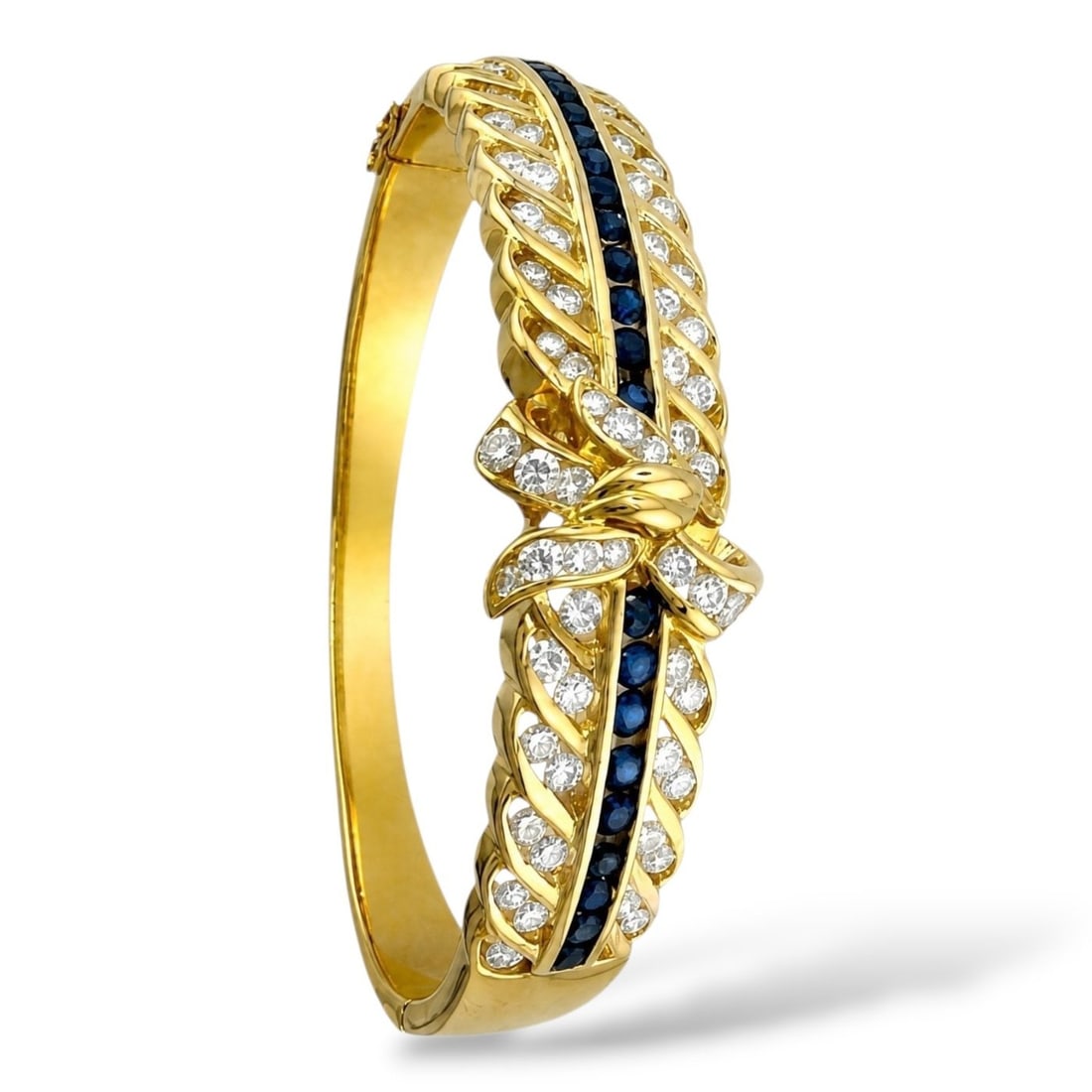 18K Yellow Gold 2.01ct Diamond and 1.00ct Sapphire Bow Bracelet: 18K Yellow Gold 2.01ct Diamond and 1.00ct Sapphire Bow Bracelet A refined yellow gold bracelet designed with two rows of diamonds and a central row of round cut sapphires, accented by a sculpted gold 