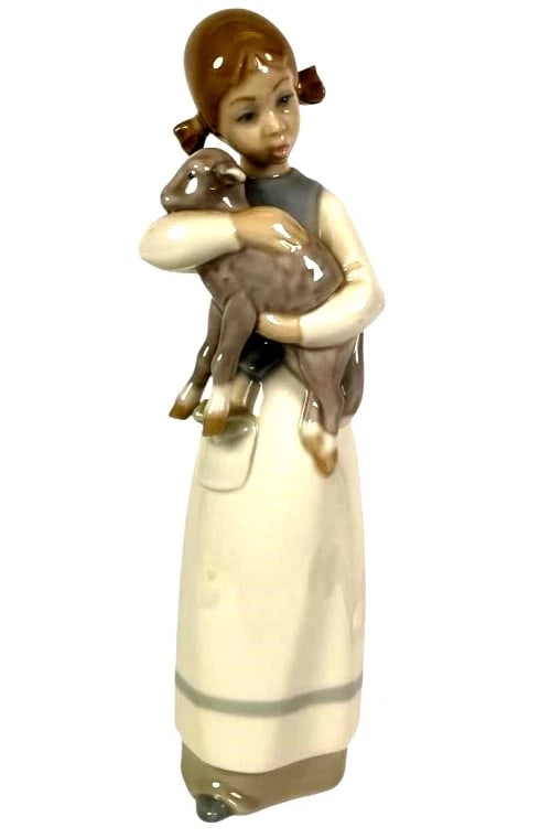 LLADRO GIRL WITH LAMB 1969-93 PORCELAIN FIGURINE 1010G: LLADRO GIRL WITH LAMB 1969-93 PORCELAIN FIGURINE 1010GLladro porcelain figurine titled 'Girl with Lamb,' model number 1010. Stands 8.5 inches tall with a glossy finish, depicting a young girl holding 
