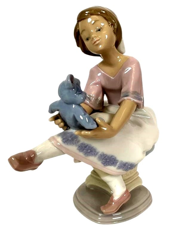 LLADRO MY BEST FRIEND 1993 SOCIETY PORCELAIN FIGURINE 7620G: LLADRO MY BEST FRIEND 1993 SOCIETY PORCELAIN FIGURINE 7620GLladro porcelain figurine titled 'Best Friend,' model number 7620. Depicts a seated girl holding a blue teddy bear. Features soft pastel colo