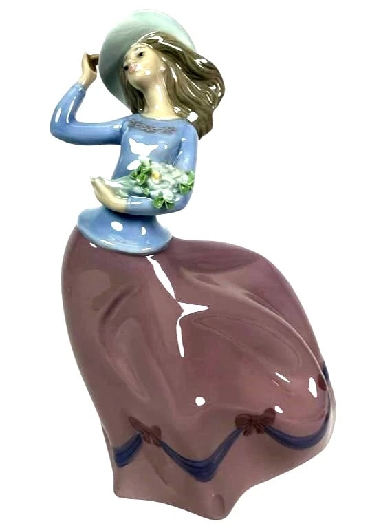 Lladro Porcelain Figurine Spring Breeze #5590: Lladro Vintage Limited Edition Porcelain Figurine Spring Breeze #5590Porcelain figurine titled Spring Breeze, model 5590 by Lladro. The figure is 7 inches tall and depicts a woman holding a bouquet of