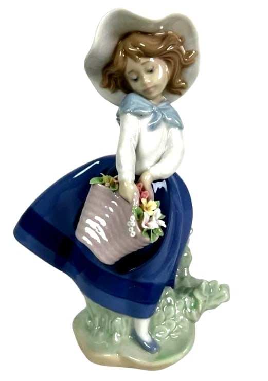 LLADRO PRETTY PICKINGS PORCELAIN FIGURINE 01005222: LLADRO PRETTY PICKINGS PORCELAIN FIGURINE 01005222Lladro porcelain figurine titled 'Pretty Pickings,' model #5222, depicting a young girl holding a basket of flowers. Handcrafted in Spain, marked on t