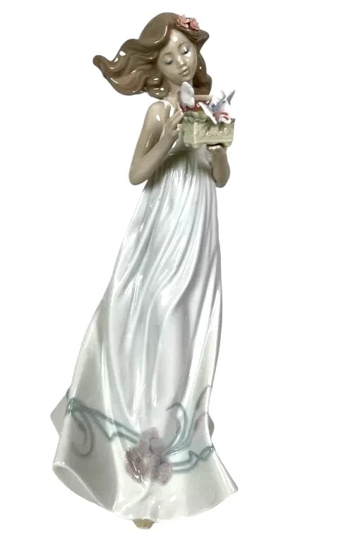 LLADRO RETIRED BUTTERFLY TREASURES ITEM #01006777: LLADRO RETIRED BUTTERFLY TREASURES ITEM #01006777Lladro porcelain figurine titled Butterfly Treasures, model number 6777. The piece measures 12.5 inches tall and features a young woman in a flowing dr