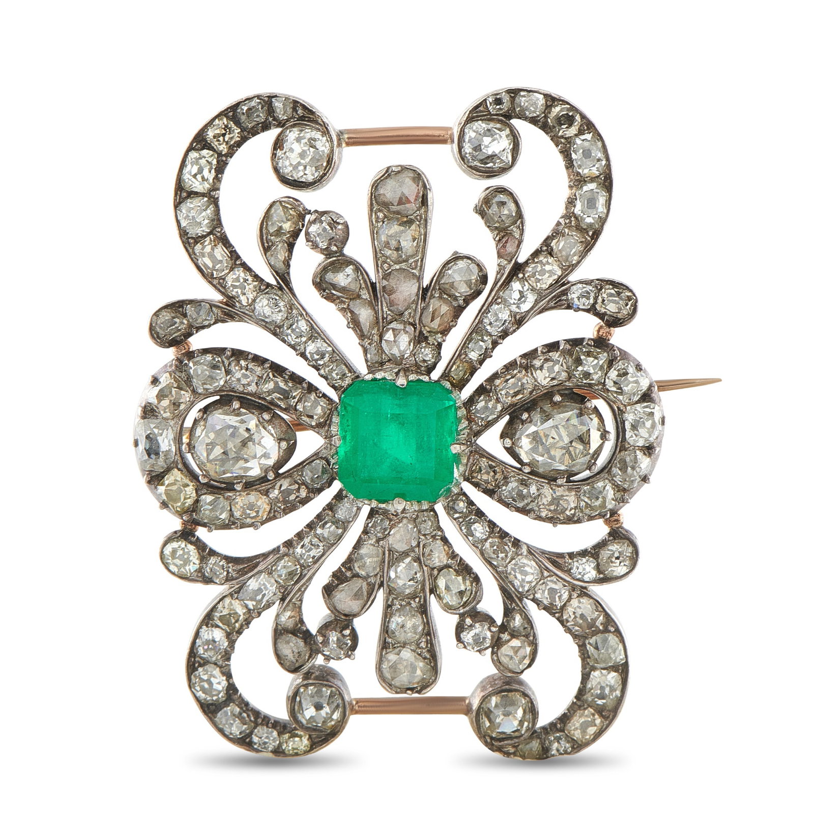 Antique 18K Rose Gold and Silver 4.0ct Diamond and Emerald Brooch: Sparkling Diamonds with a total weight of 4.0 carats allow this antique brooch to effortlessly catch the light. Crafted from a combination of 18K Rose Gold and Silver, a 2.0 carat Emerald center stone