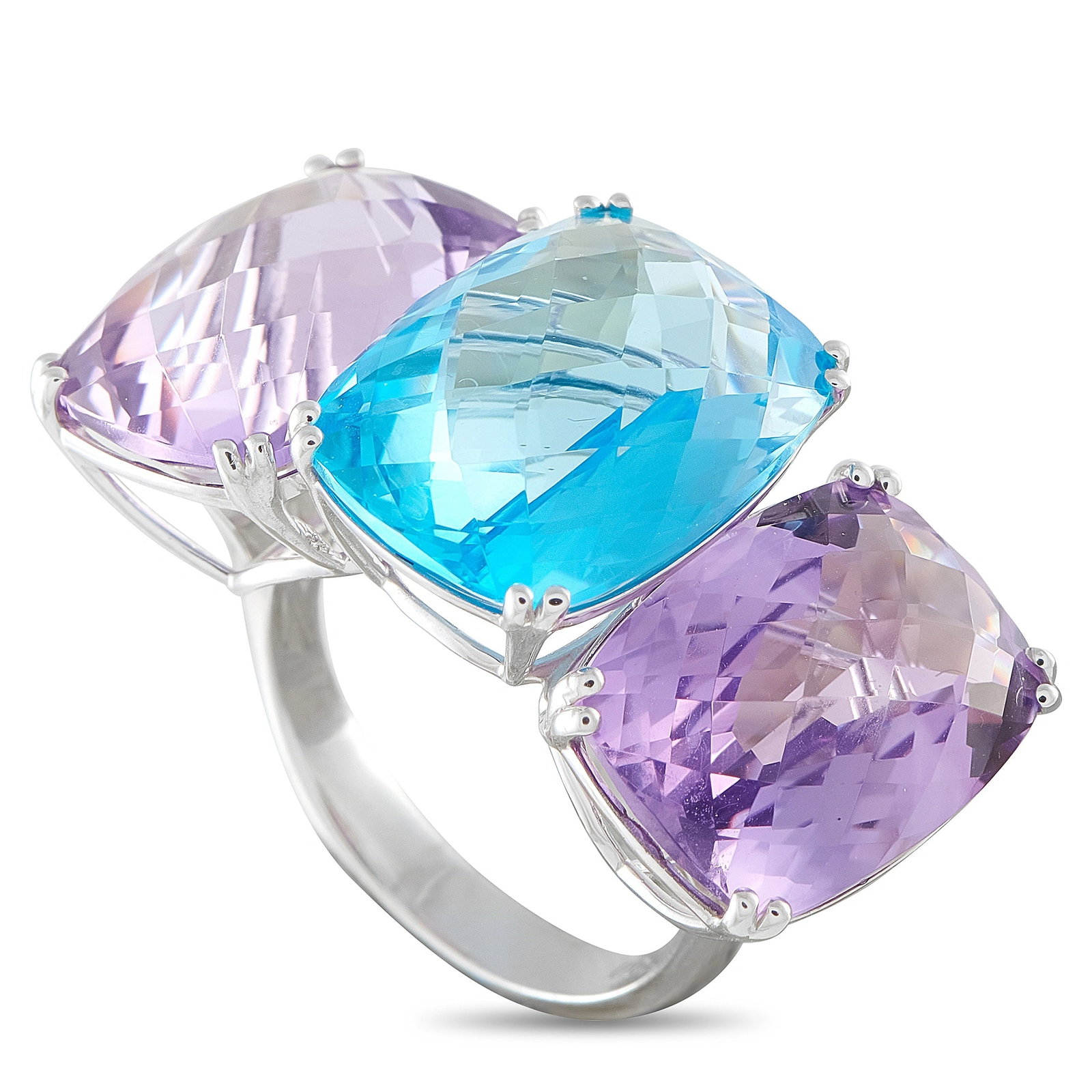 Exclusive 18K White Gold Amethyst and Topaz Three-Stone Ring: This bold 18K white gold ring features three large cushion-cut gemstones – two vivid purple amethysts flanking a rich blue topaz – set in a striking bypass design. The ring weighs 10.2 grams and i