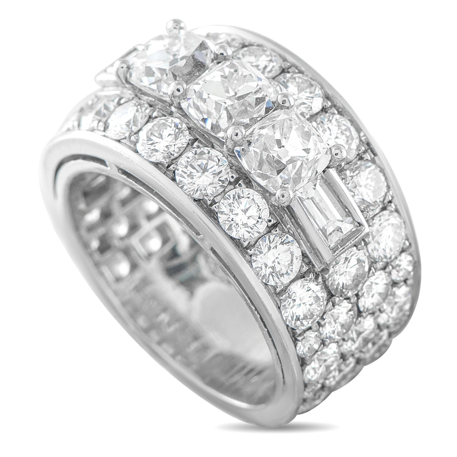 Bvlgari Platinum 6.50ct Diamond Ring: This vintage Bvlgari ring is crafted in platinum in a wide tapered band design, showcasing three cushion-cut diamonds and a vertical baguette diamond at the center, flanked by rows of pave-set round d