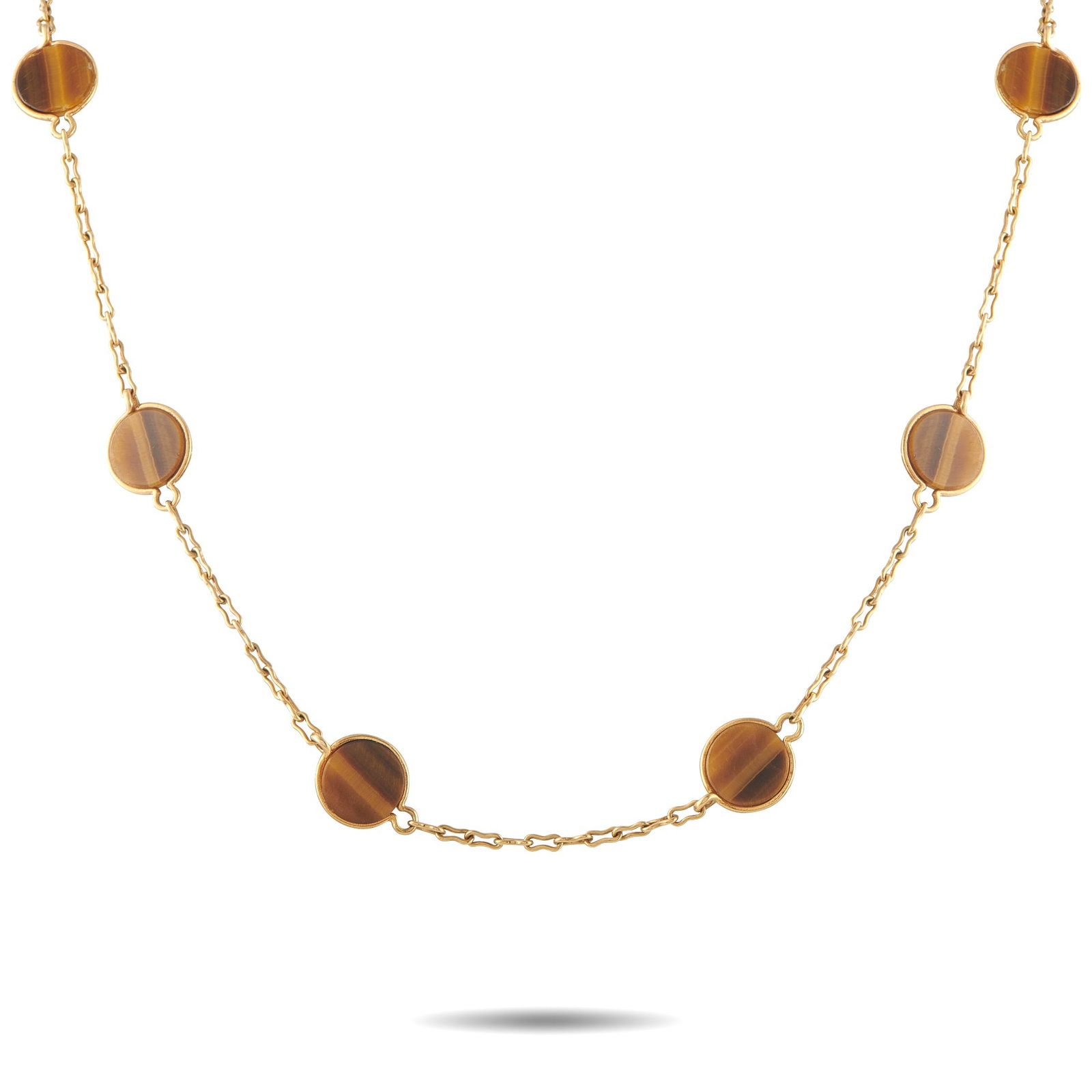Van Cleef & Arpels Vintage 18K Yellow Gold Tiger Eye Necklace: This vintage Van Cleef & Arpels necklace draws its warmth from richly banded tiger’s eye in shades of honey, chestnut, and deep caramel. Set along a 31-inch yellow gold chain, the circular plaques i