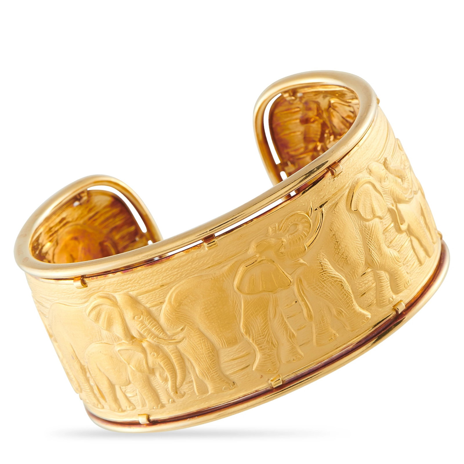 Carrera Y Carrera 18K Yellow Gold Elephant Cuff Bracelet: This bold Carrera y Carrera cuff bracelet is simply enchanting. Crafted from lustrous 18K Yellow Gold, an engraved depiction of elephants elevates the design. It measures 6.5” long and weighs 39