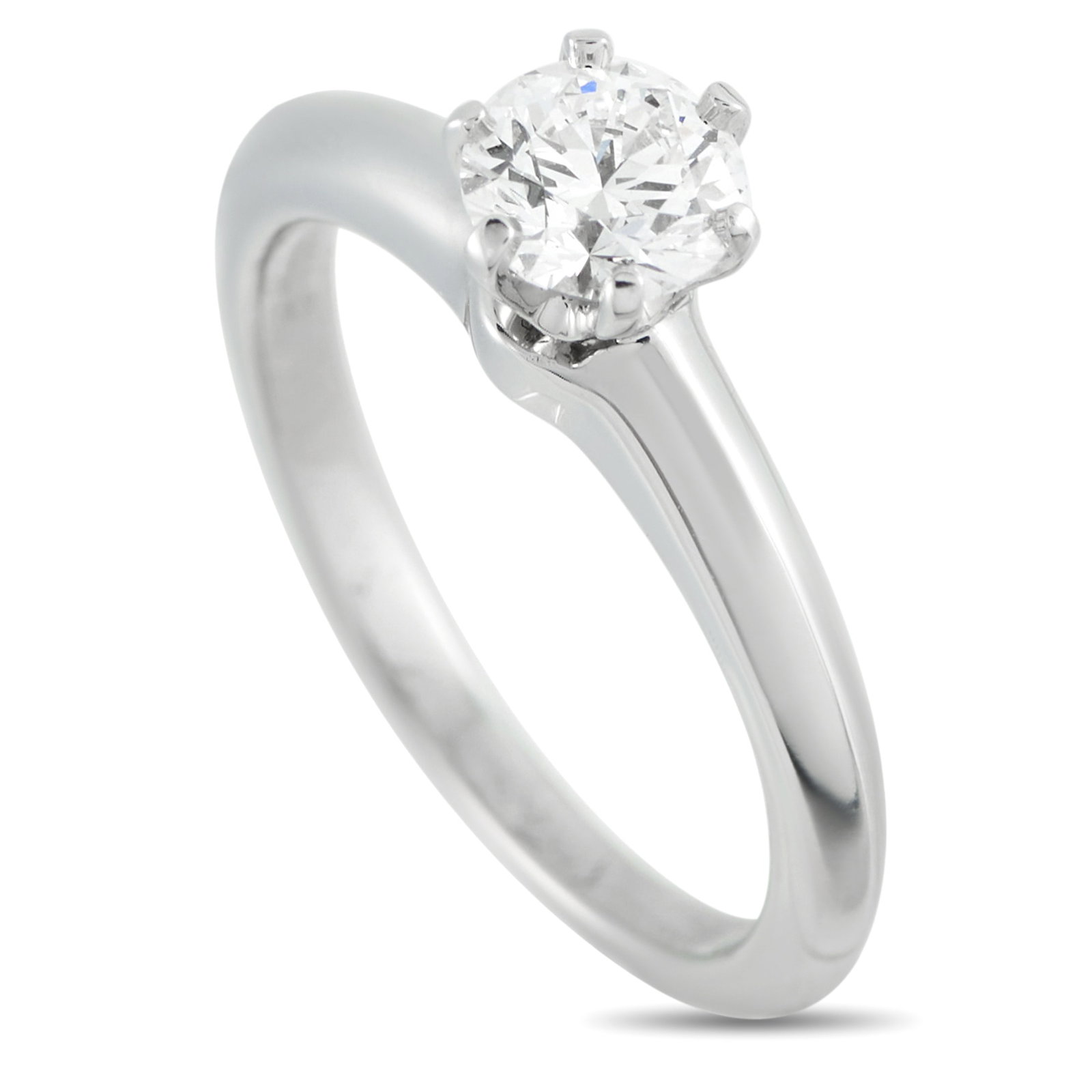 Tiffany & CO. Platinum 0.56ct Diamond Solitaire Ring: This Tiffany & Co. solitaire ring is an instant heirloom piece. Set in Platinum, the understated setting beautifully showcases the 0.56 carat round-cut Diamond center stone. It features a 2mm wide ban