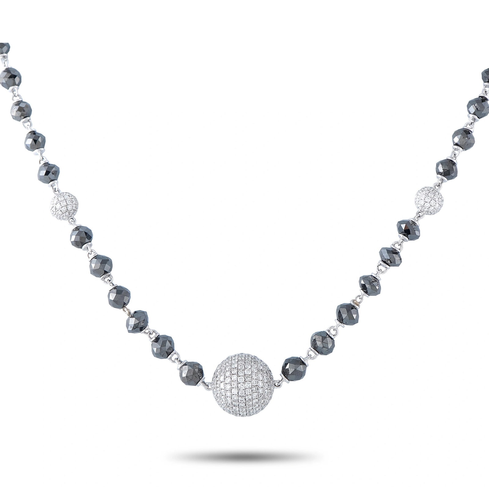 18K White Gold 47.25ct White and Black Diamond Beaded Necklace: This necklace is crafted from 18K white gold and designed as a strand of faceted black diamond beads accented by three diamond-set pavé stations. It features approximately 3.25 carats of white diamon