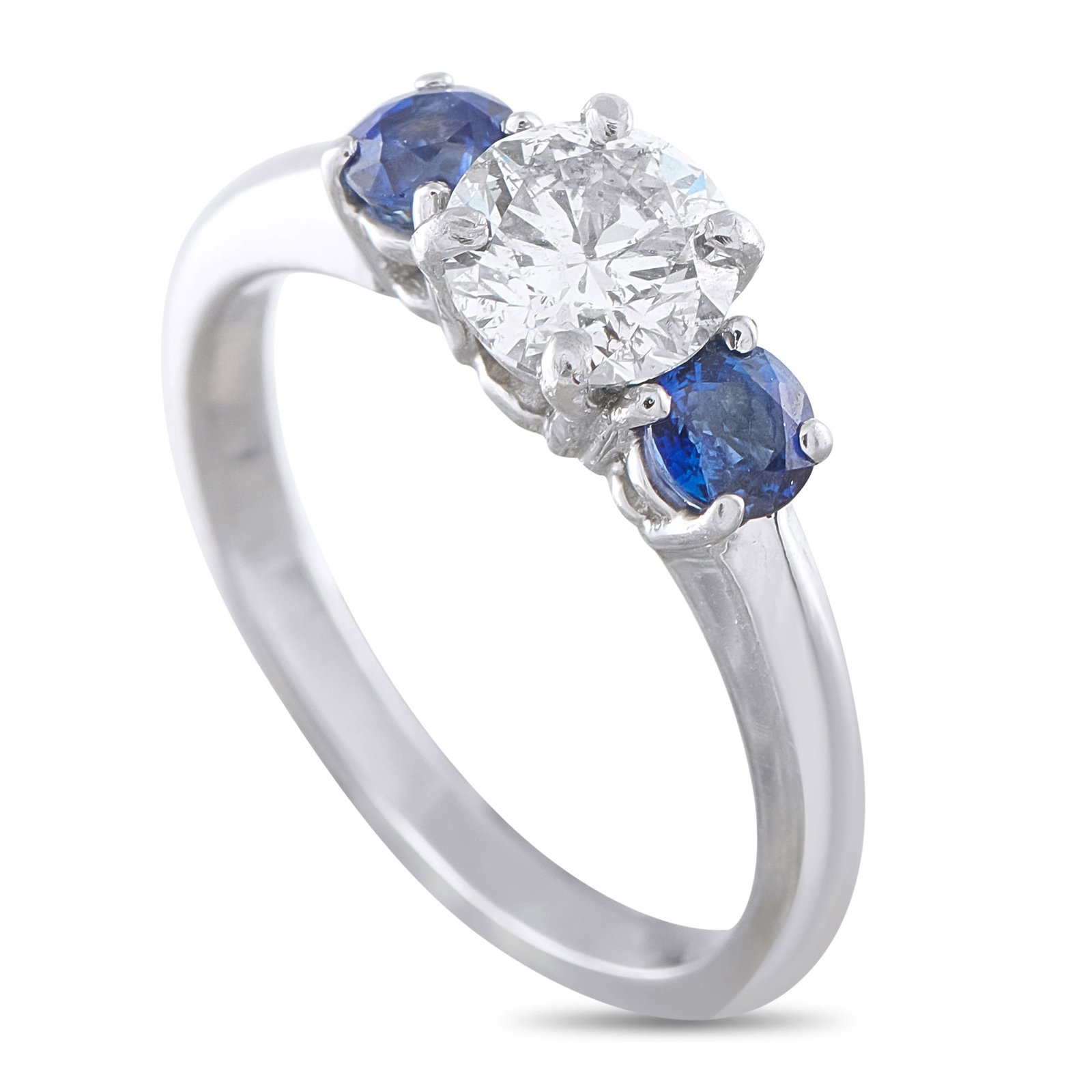 Platinum 0.80ct Diamond Sapphire Three Stone Ring: This platinum three-stone ring showcases a round brilliant-cut diamond weighing approximately 0.80 carats at its center, flanked by two rich blue round sapphires totaling 0.40 carats. The ring has a t