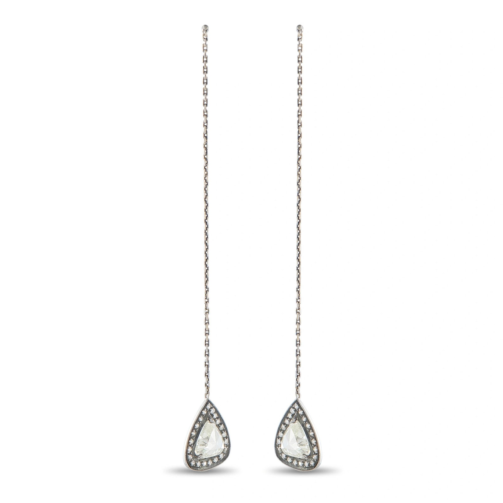 14K White Gold 3.23ct Diamond Dangle Earrings: A striking pair of long drop earrings in 14K white gold, each suspending a pear-shaped halo pendant from a delicate link chain. Each pendant centers a large trillion-cut diamond framed by a milgrain-b