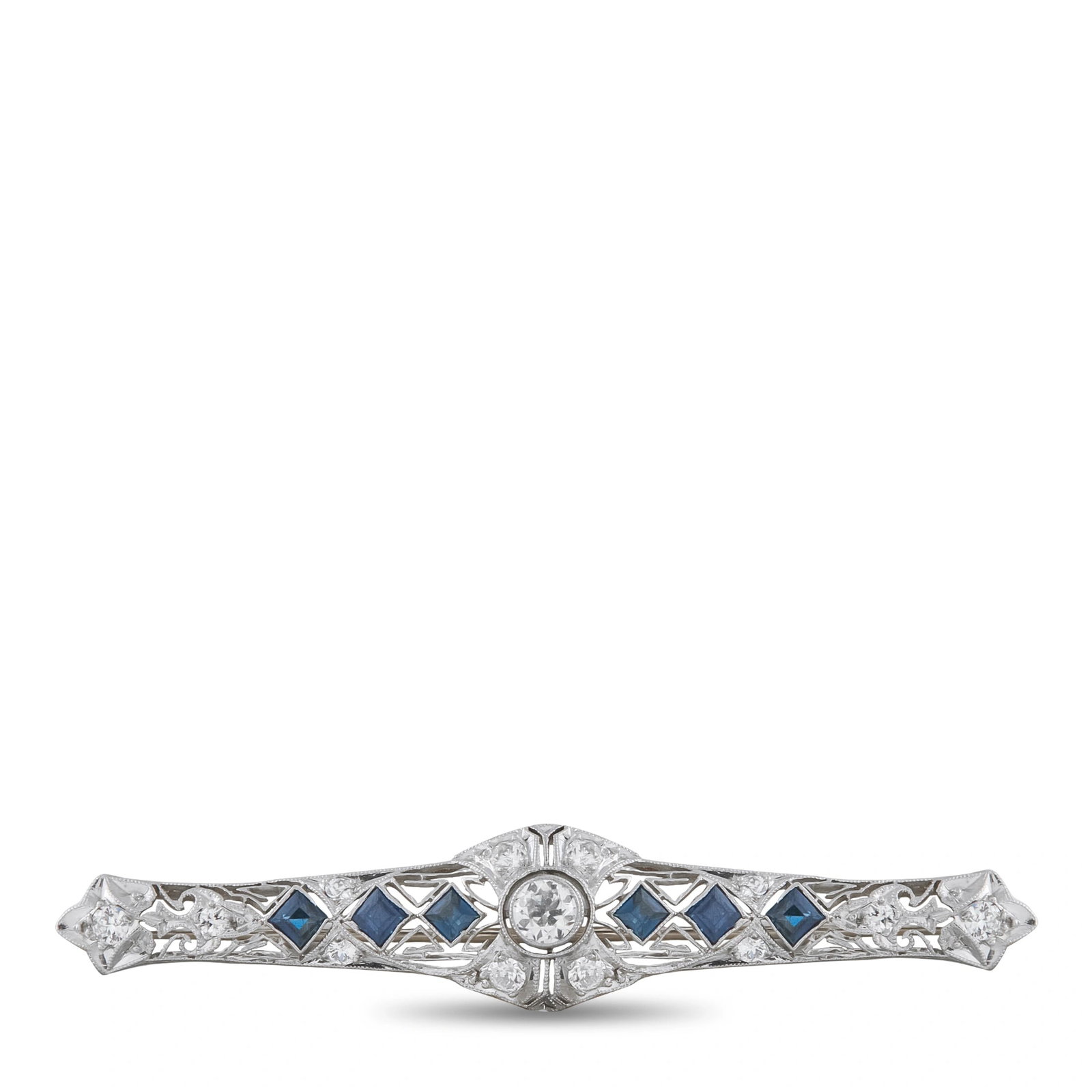 Platinum 0.90ct Diamond and Sapphire Brooch: Art Deco elements make this luxury brooch an instant classic. Set in Platinum, Diamonds with a total weight of 0.90 carats allow it to effortlessly emanate light. Sapphire accents offer an exciting po