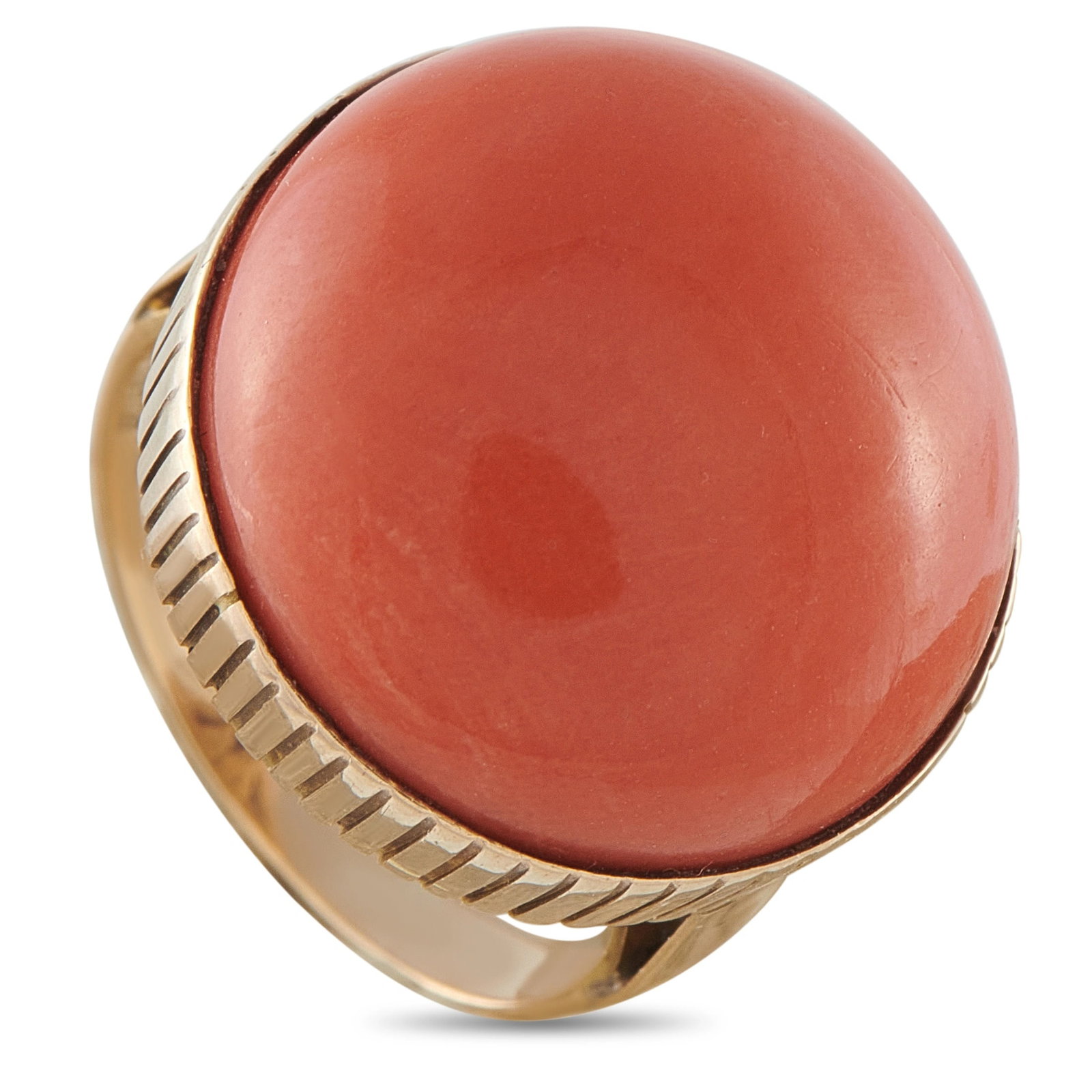 Vintage 14K Yellow Gold Coral Dome Cocktail Ring: A striking cocktail ring in 14K yellow gold, centering a large polished coral sphere cabochon in a bezel-style setting with a fluted gold shank. Weighing 9.0 grams. This piece is offered in estate con