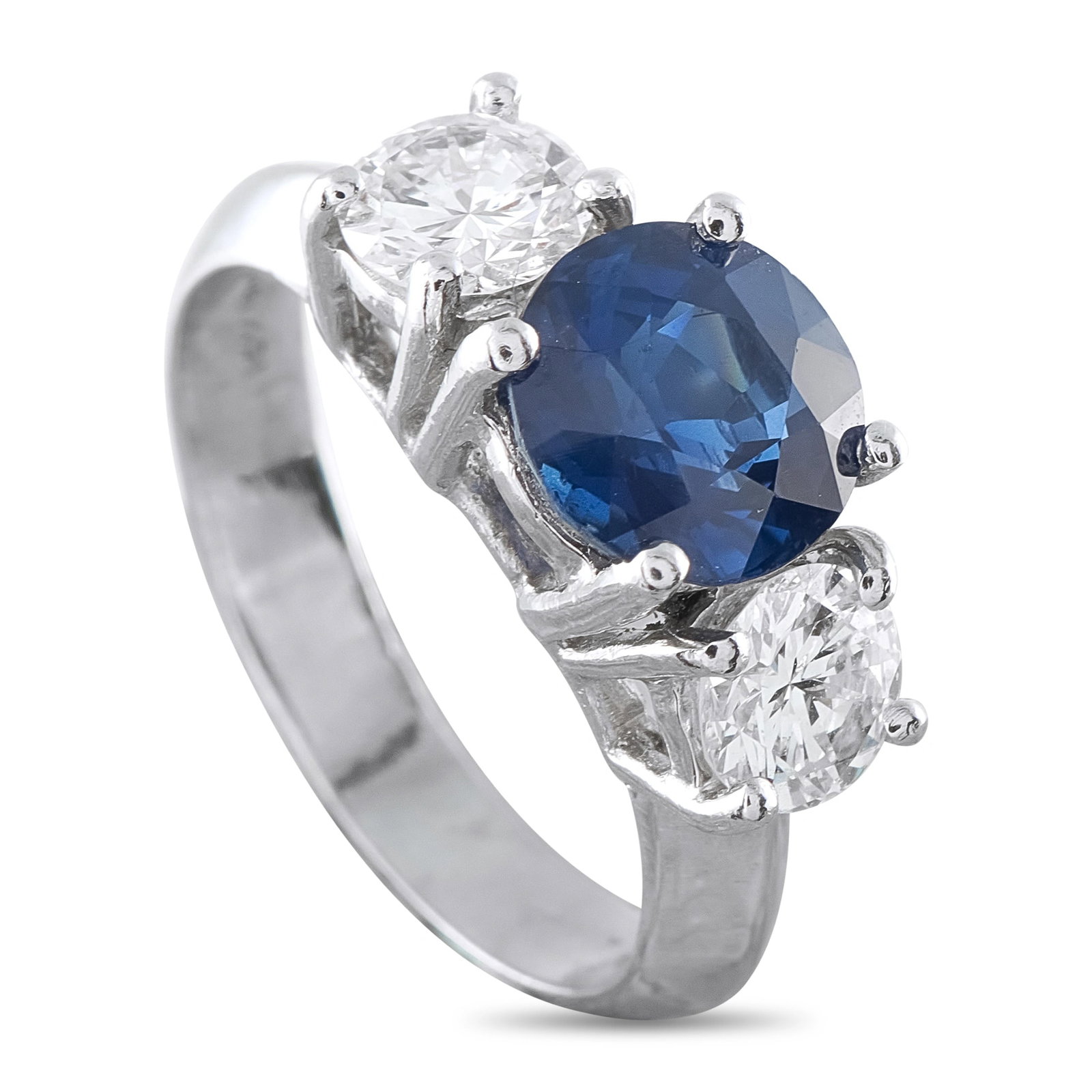 Platinum 0.98ct Diamond and Sapphire Three-Stone Ring: A classic and refined three-stone ring in platinum, featuring a vivid blue sapphire totaling 2.15 ct, framed by round brilliant diamond accents totaling 0.96 ct (H, SI1). The sapphire is presented in 