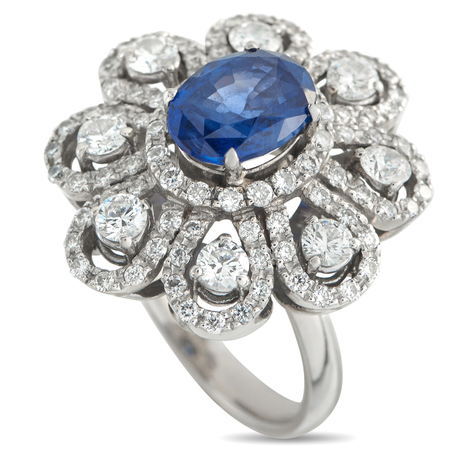 18K White Gold 1.40ct Diamond and Sapphire Ring: This floral ring will serve as an elegant addition to any luxury jewelry collection. A stunning 2.40 carat Sapphire makes a statement at the center, while a dazzling array of Diamonds totaling 1.40 ca