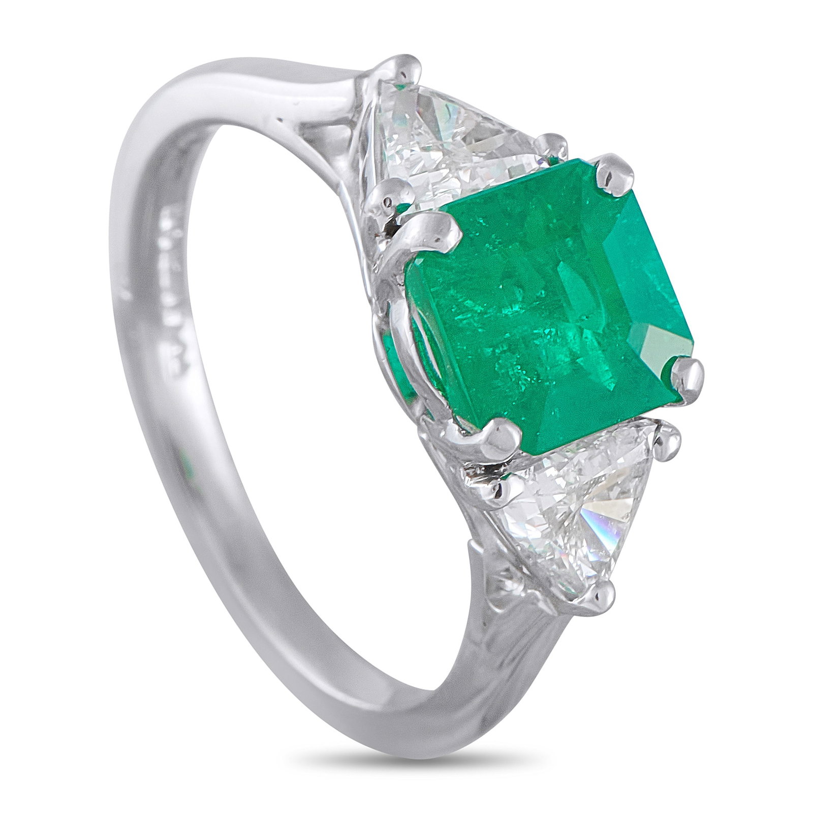 Platinum 0.60ct Diamond and Emerald Ring: A ring built almost entirely around the pull of emerald. Fresh and cool to the eye, the 1.24-carat center stone sits right at the center with four prongs securing its corners. Trillion-cut diamonds on