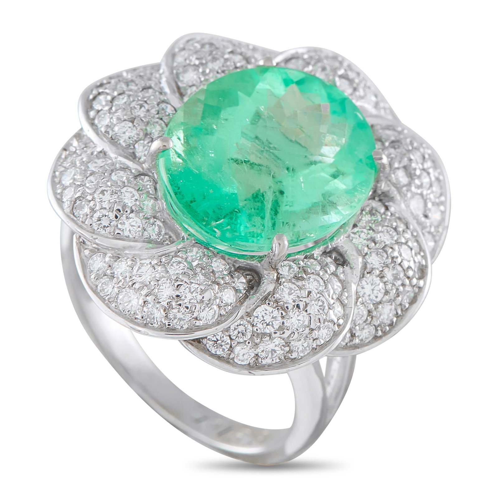 Platinum 0.65ct Diamond and Emerald Ring: A breathtaking 6.91 carat Emerald adds a stylish pop of color to this luxury ring. Crafted from Platinum, the detailed setting features Diamonds totaling 0.65 carats in an abstract floral motif. It fe