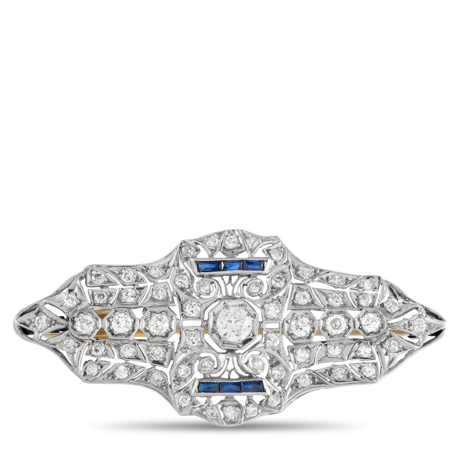 18K White Gold 3.0ct Diamond and Sapphire Art Deco Brooch: A clean expression of Art Deco design. This white gold brooch features over 3.0 carats of diamonds set in crisp, geometric rows with delicate milgrain edges. Two slim channels of step-cut sapphires