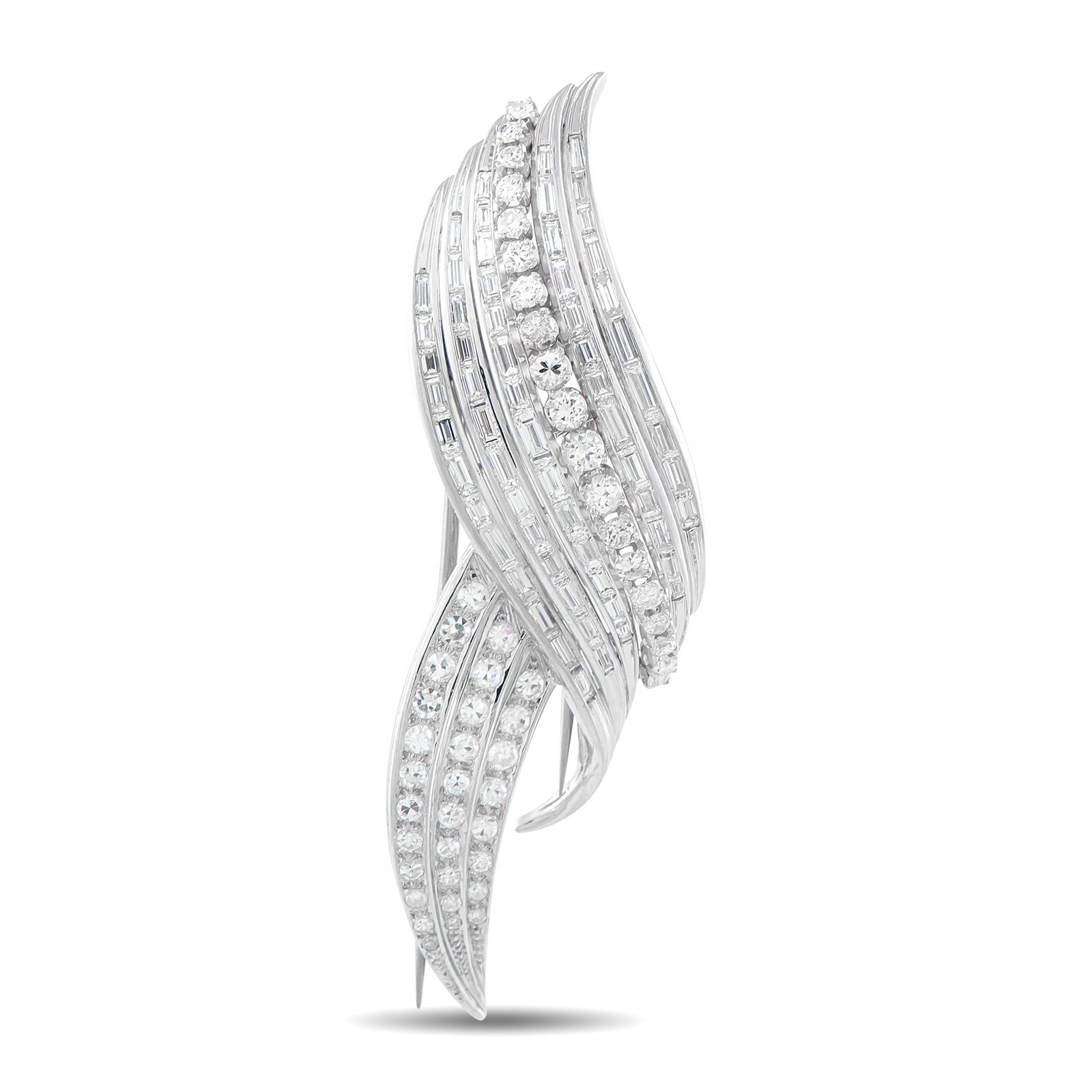 Platinum 7.25ct Diamond Brooch: A gracefully curved Platinum setting provides this luxury brooch with an enduring design. The perfect accent to any ensemble, Diamonds with a total weight of 7.25 carats allow this piece to effortless