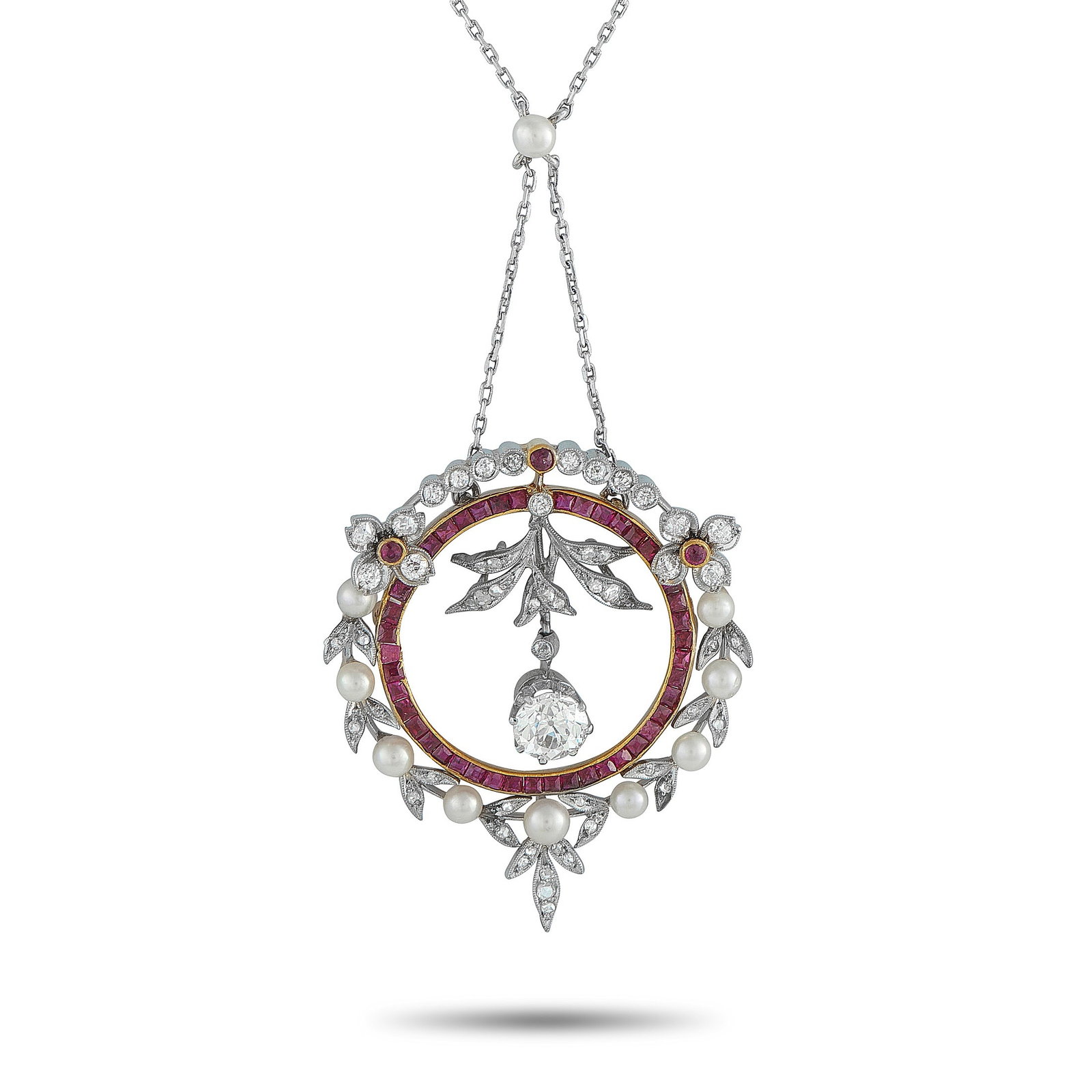 Platinum and 18K Yellow Gold 1.95ct Diamond and Ruby Pendant: This luxury necklace is filled with intricate details. A 1.20 carat Diamond dangles in the center of the circular pendant, while additional Diamonds totaling 0.75 carats effortlessly catch the light. 