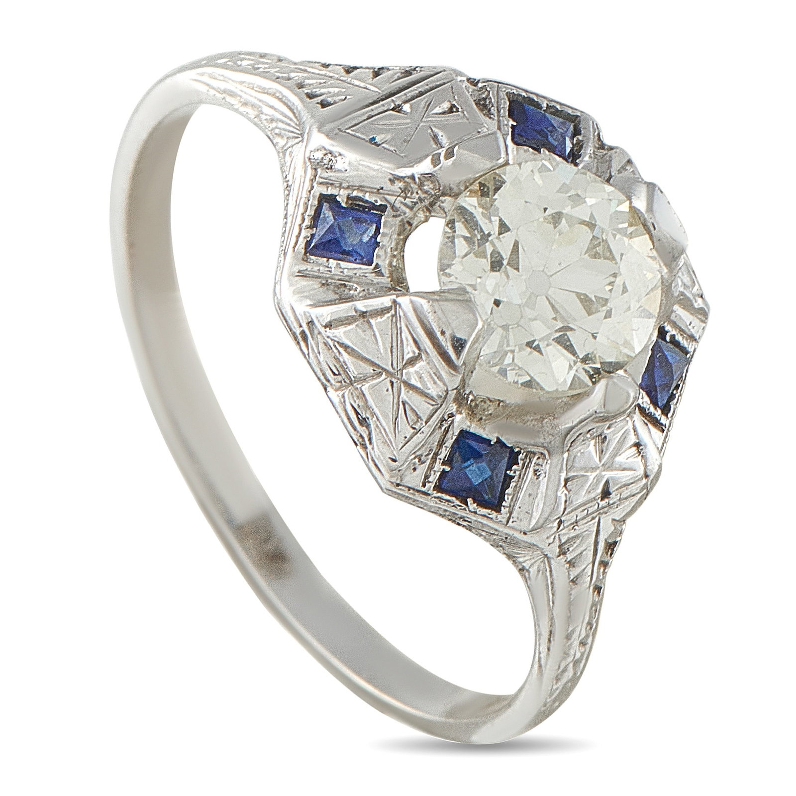 18K White Gold 0.99ct Diamond and Sapphire Octagon Ring: Light, color, and geometric detail come together in this white gold ring. A 0.99-carat diamond rests on an octagonal base, with four prongs securing it with a sense of suspension. The etched shoulders