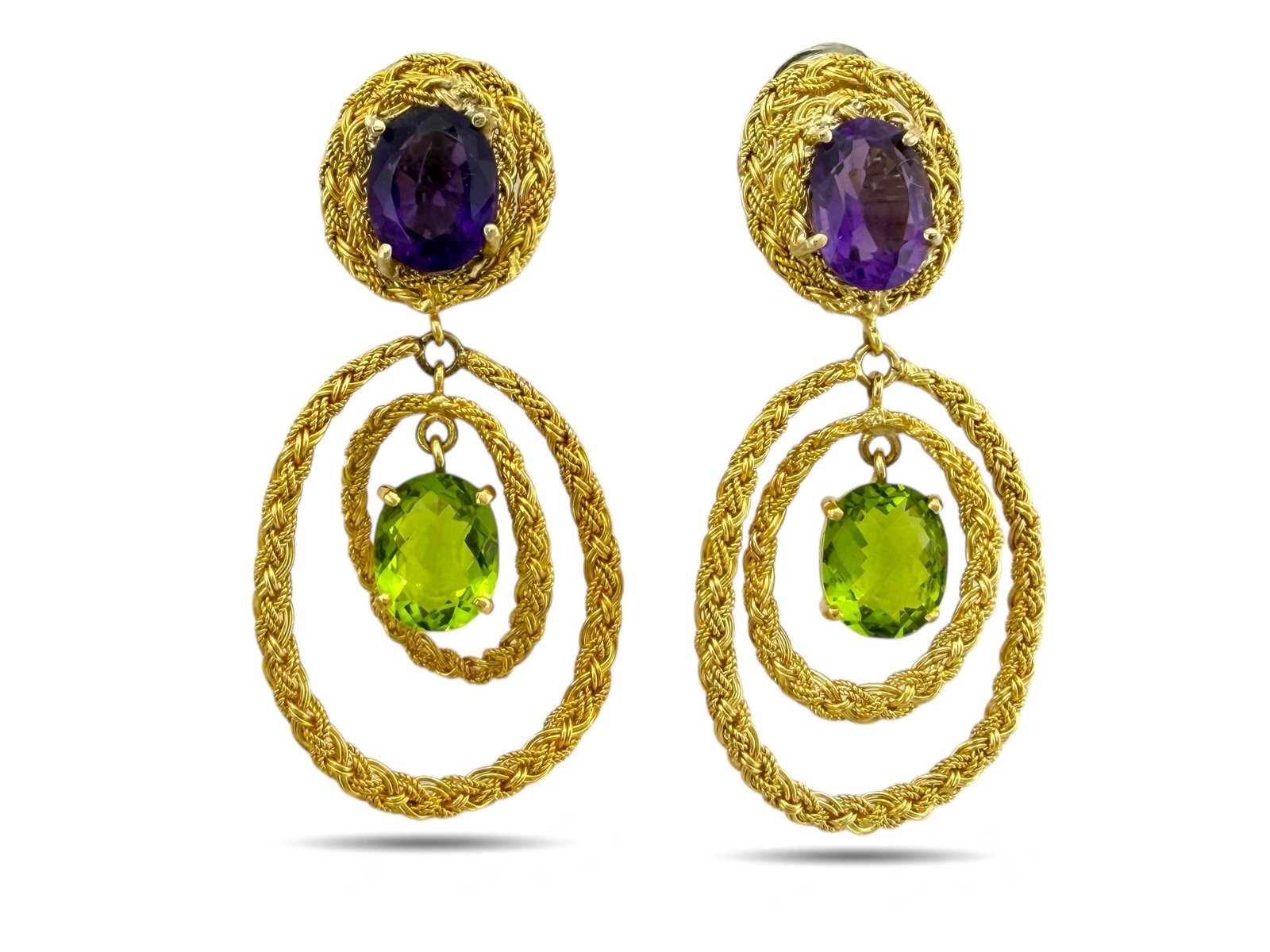 18K Yellow Gold Amethyst and Peridot Clip: Italian 18K Yellow Gold Amethyst and Peridot Clip-On Earrings Elegant and vibrant, these 18K yellow gold clip-on earrings feature a striking combination of oval-cut amethysts and peridots. Each earrin