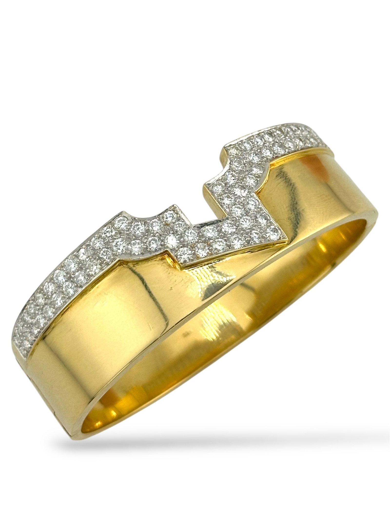 18K Yellow Gold Hinge Bracelet: 18K Yellow Gold Hinge Bracelet with 3.1 Carats of Diamonds This luxurious 18K yellow gold bracelet showcases timeless refinement with a bold and structured silhouette. Designed with a secure hinged me