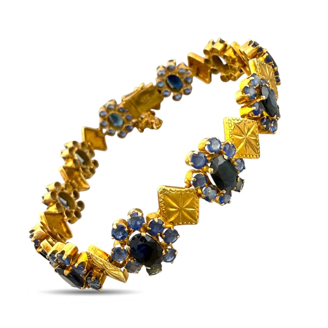14K Yellow Gold 9.5ct Sapphire Floral Motif Bracelet: 14K Yellow Gold 9.5ct Sapphire Floral Motif Bracelet A beautifully composed vintage bracelet featuring a series of delicate floral motifs, each centered with an oval sapphire and surrounded by