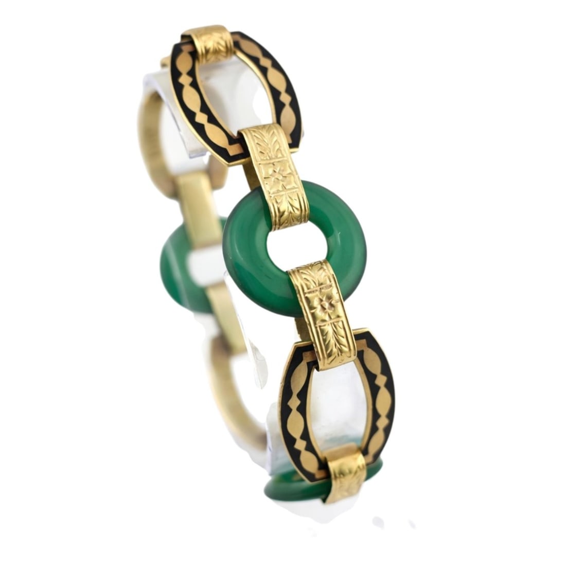 Antique Art Deco Carved Undyed Green Onyx and Black Enamel 14K Gold Bracelet: Antique Art Deco Carved Undyed Green Onyx and Black Enamel 14K Gold Bracelet An exceptional and rare Art Deco bracelet, masterfully handcrafted in solid 14K gold and showcasing beautifully carved, und