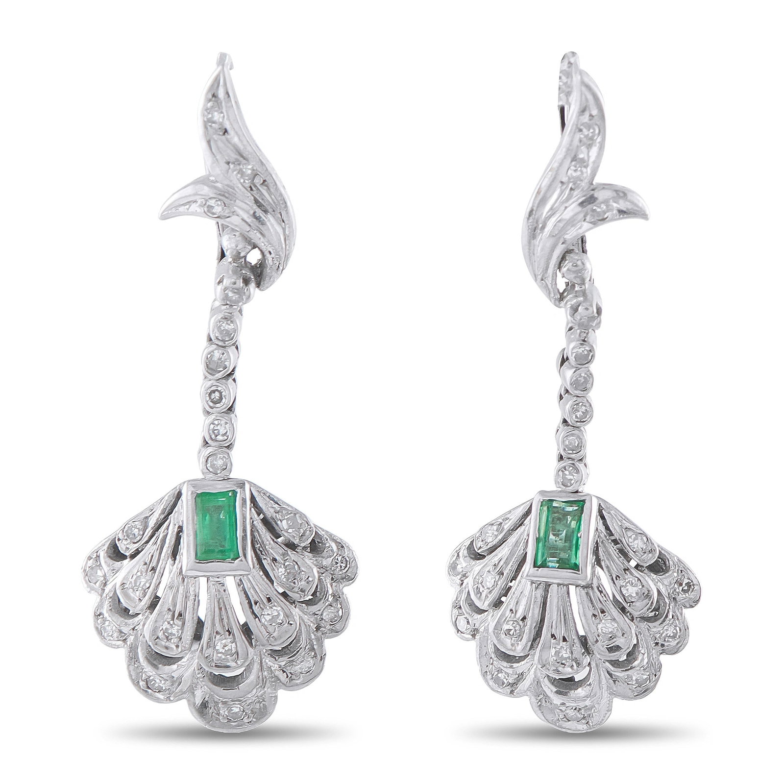 Antique 18K White Gold Diamond and Emerald Earrings: This estate pair of antique-style 18K white gold dangle earrings showcases a diamond-set flame motif suspending a scalloped, fan-shaped drop centered with a bezel-set emerald-cut emerald. The earrings