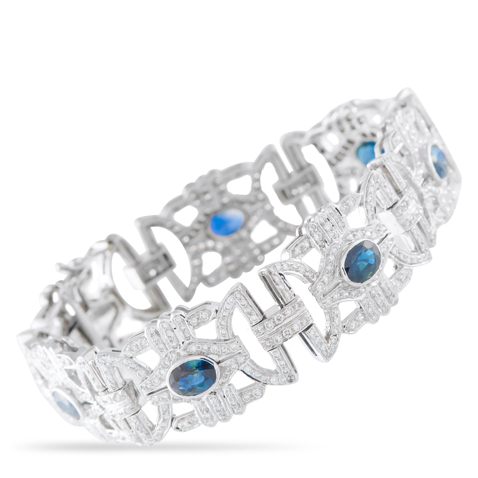 18K White Gold 4.50ct Diamond and Sapphire Bracelet: An intricate, openwork design makes this bracelet incredibly elegant. Crafted from 18K White Gold, Diamonds with a total weight of 4.50 carats highlight all this piece’s intricacies. At the center, 