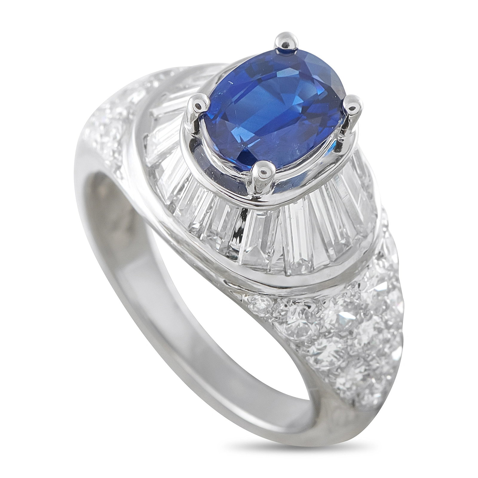 Van Cleef & Arpels Platinum 1.95ct Diamond and Sapphire Ring: This vintage Van Cleef & Arpels ring is crafted in platinum and centers on an oval-cut blue sapphire weighing approximately 1.45 carats, surrounded by a tapered baguette diamond halo with pave-set rou