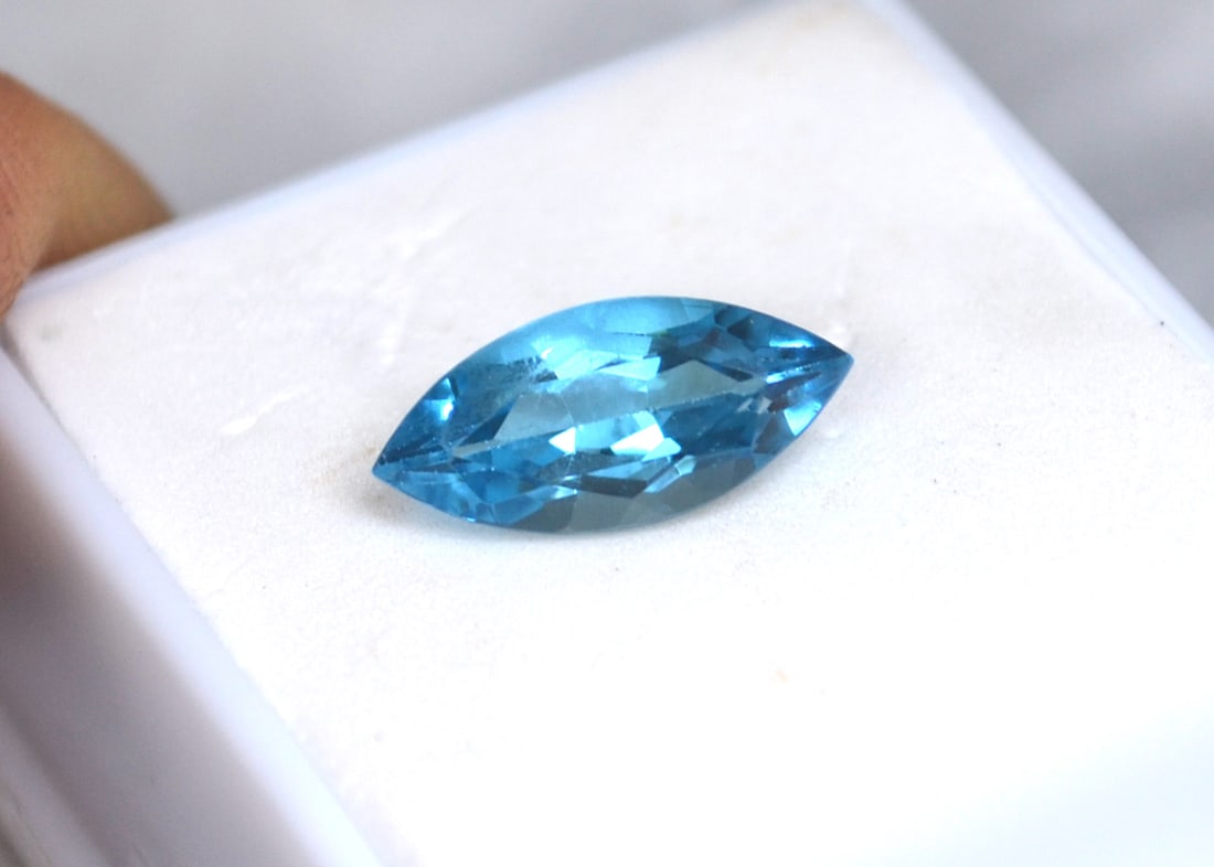 3.95 Carat Marquise Cut Swiss Blue Topaz: Gorgeous Topaz. Just an exceptional stone. Natural stone but heated and irradiated to get its color, as all Blue Topaz are. For Proxibid bidders, shipping is a flat rate of $6, no matter how many