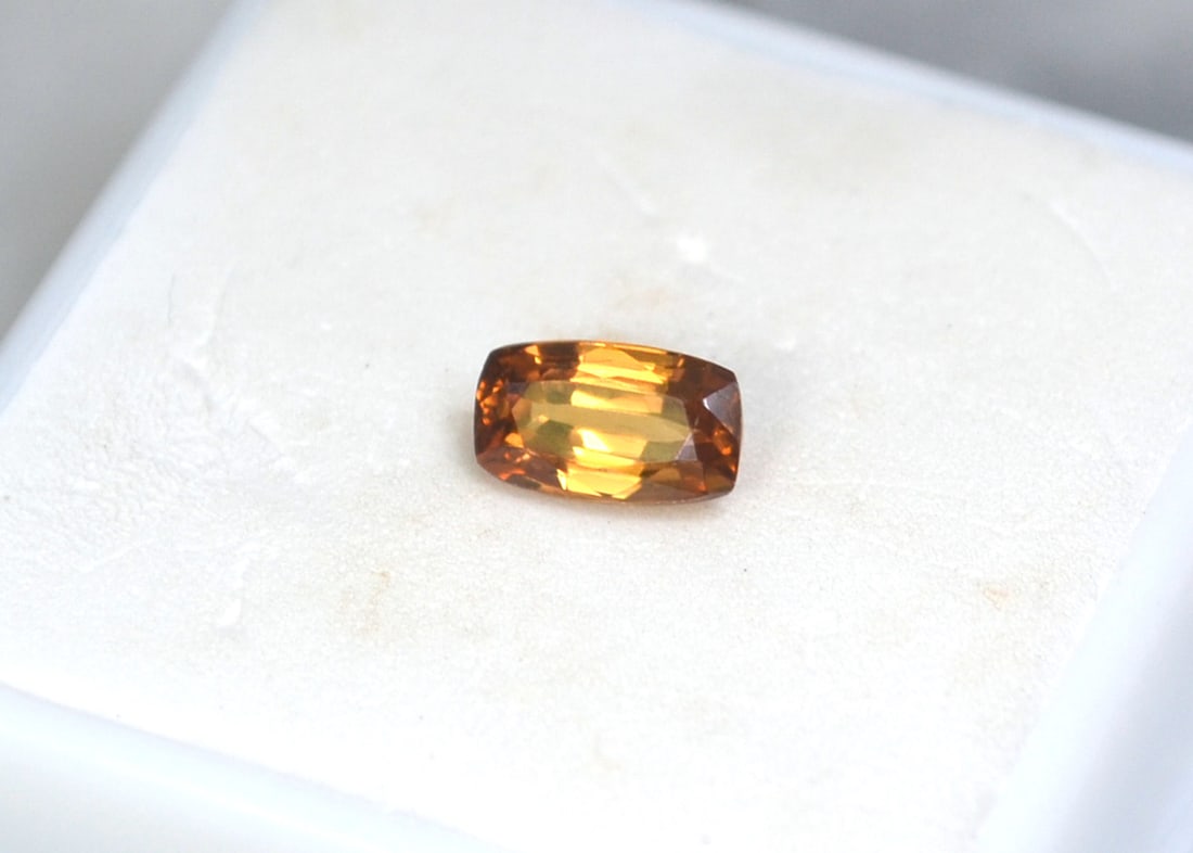 1.54 Carat Cushion Cut Zircon: Gorgeous Zircon. Great honey orange color. Zircon is a natural stone, not to be confused with Cubic Zirconia. Natural and untreated. For Proxibid bidders, shipping is a flat rate of $6, no matter how
