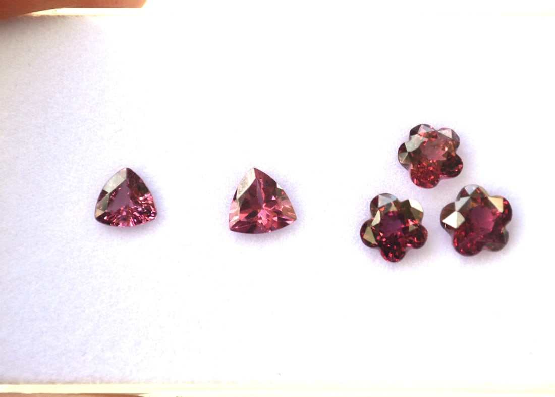 5.14 Carats of Jewelry Grade Pink Garnet: Beautiful matched set of flower cut stones weighing 3.70 carats. The two trillions weigh 1.44 carats. All very fine Garnets with bright and vibrant color. Most gems sold online aren't jewelry grade.