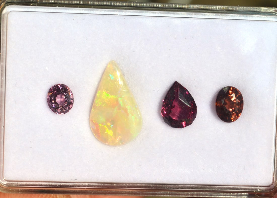 8.18 Carats of Jewelry Grade Mixed Gems: High grade set of gemstones. Included is a 1.98 carat Zircon, a 2.80 carat Garnet, a 2.65 carat Australian Opal, and a 0.75 carat Spinel. All high quality, colorful stones with good clarity and cuttin