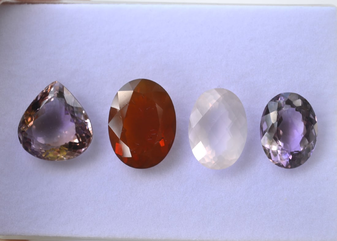 57.31 Carats of Jewelry Grade Mixed Gems: Beautiful set of rare and unusual stones. The Ametrine weighs 19.20 carats. The Fire Opal weighs 13.65 carats. The Amethyst weighs 10.80 Carats and the Rose Quartz weighs 13.66 Carats. The Fire Opal i