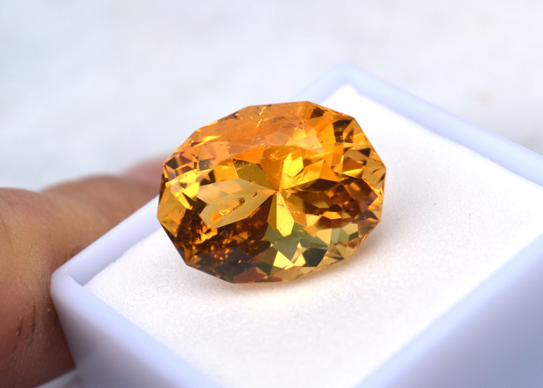 16.06 Carat Fancy Oval Cut Citrine: Fine Citrine! A few scattered inclusions, which is why the opening bid is so low. The cutter did an expert job at blending them in. Natural and untreated. For Proxibid bidders, shipping is a flat rate