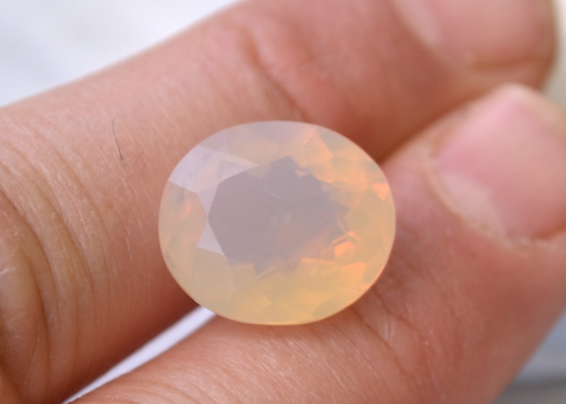 10.00 Carat Oval Cut Opal: Nice Opal with good color. Great combination of white and orange. Just a great, rare stone. Natural and untreated. For Proxibid bidders, shipping is a flat rate of $6, no matter how many lots won.