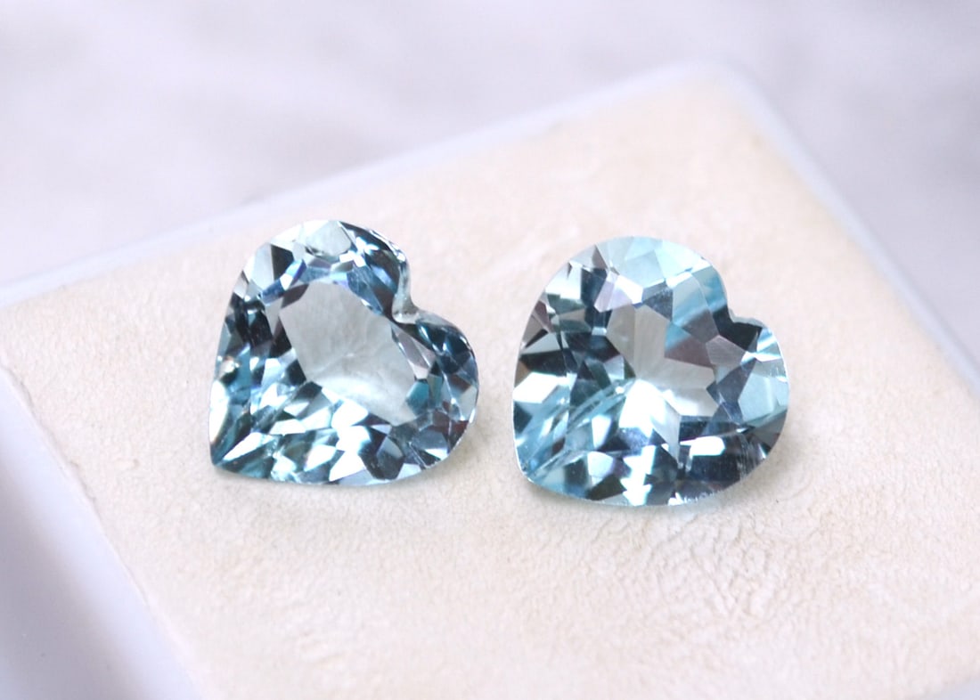 7.67 Carat Near Matched Pair of Heart Shaped Sky Blue Topaz: Nice pair of Topaz. Very near match but not perfect. Natural stones but heated and irradiated to get their color, as all Blue Topaz are. This is an industry accepted practice applied to all Blue