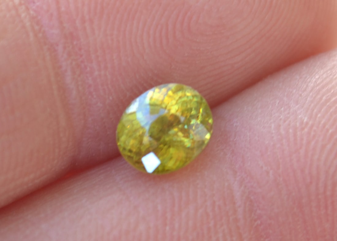 1.52 Carat Oval Cut Sphene: Beautiful Sphene with tons of fire. Sphenes have twice the fire of Diamond, so this stone really pops in direct sunlight. The fire is difficult to capture photographically, so we intentionally
