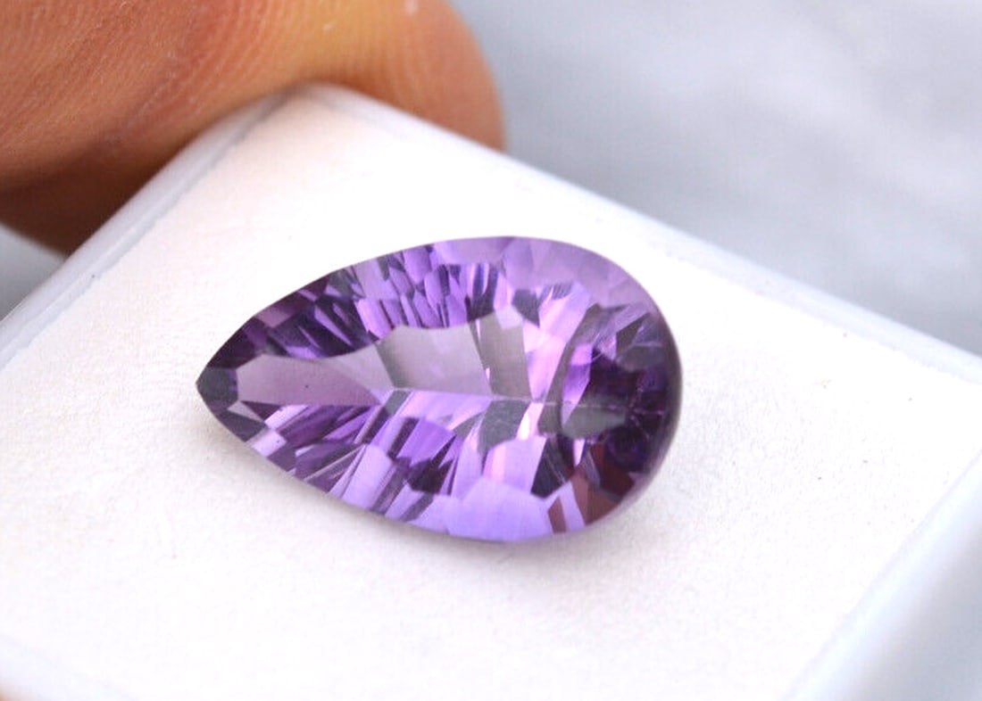 8.25 Carat Fancy Pear Cut Amethyst: Beautiful Amethyst with a fine, fancy cut. Just a top quality stone. Natural and untreated. For Proxibid bidders, shipping is a flat rate of $6, no matter how many lots won. For Live Auctioneers