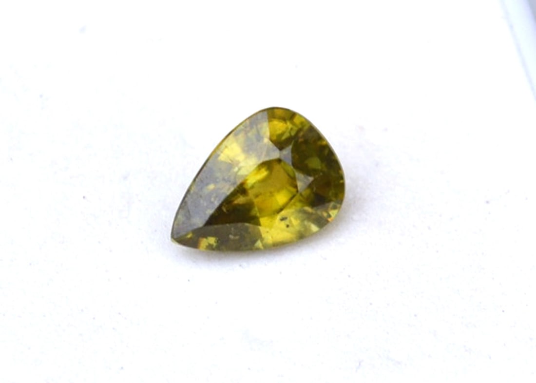 1.48 Carat Pear Cut Sphene: Gorgeous example of this rare and fiery form of gemstone. Fantastic Green color, which is the rarest and most expensive color for Sphene. Sphene is only mined in a few places on earth, most notably