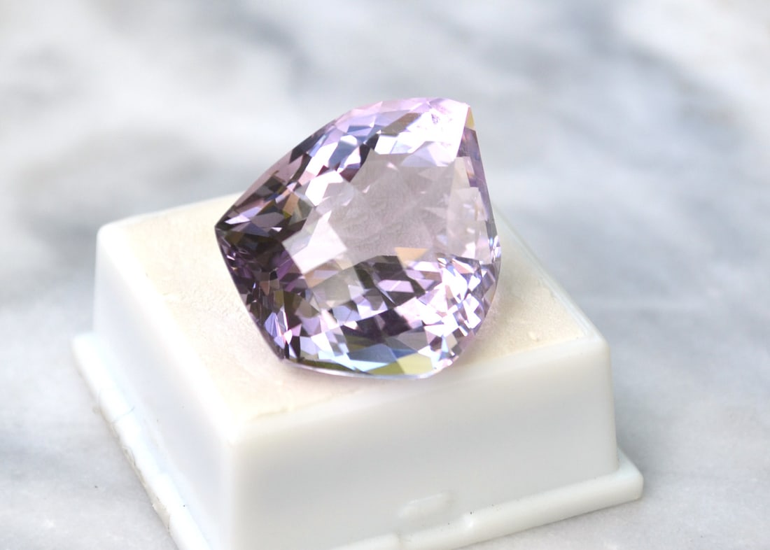 59.65 Carat Checkerboard Cut Rose De France Amethyst: Nice Amethyst with a great light purple color. Freeform stone, cut with checkerboard sides. Priced at only $1 per carat, which is a steal for a large Amethyst. Natural and untreated. Most gems sold