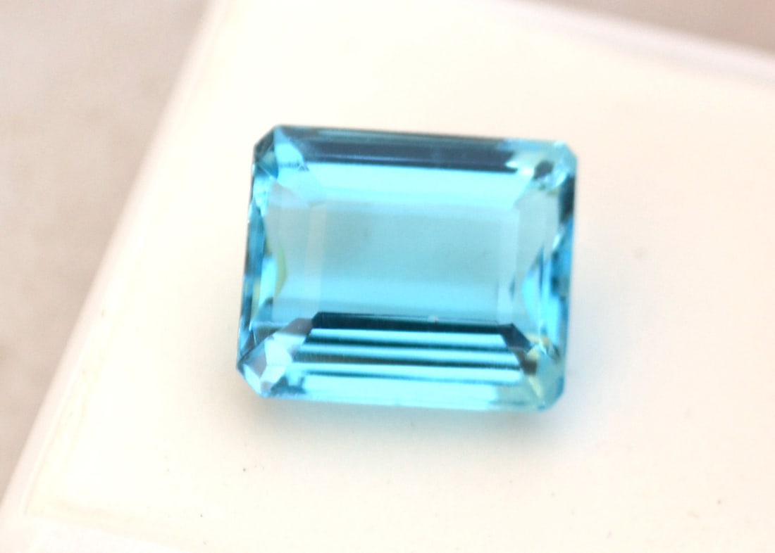10.01 Carat Octagon Cut Swiss Blue Topaz: Gorgeous Topaz. Natural stone. All Blue Topaz are heated and irradiated to get their color. This is an industry accepted standard applied to all Blue Topaz. Most gemstones bought online aren't very hi